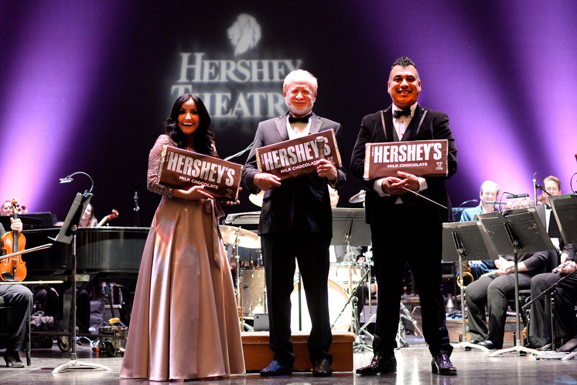 Hershey Symphony guest performers receive giant Hershey bars on stage at the Hershey Theatre
