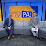 two men on a couch on a TV news set. The backdrop says "Good Day PA!"