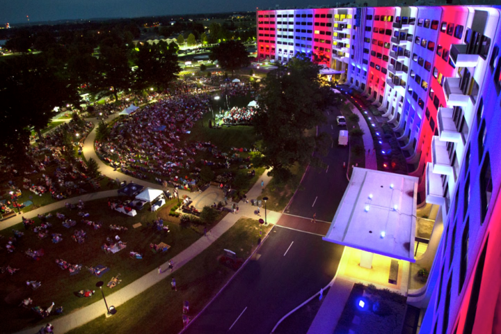 overhead view of building with red, white, and blue lights at night